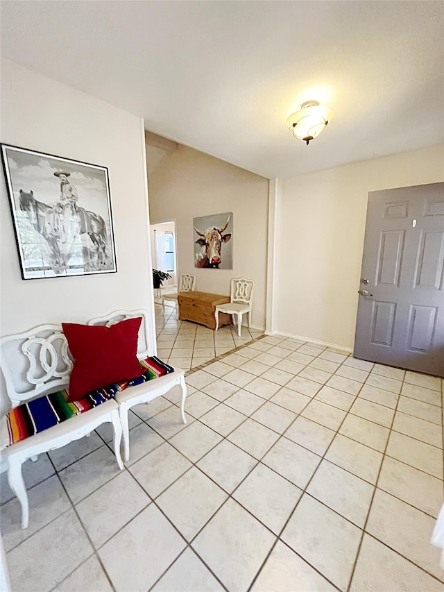 interior space with lofted ceiling and light tile patterned floors