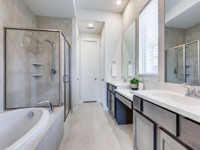 bathroom with independent shower and bath, tile patterned floors, and vanity