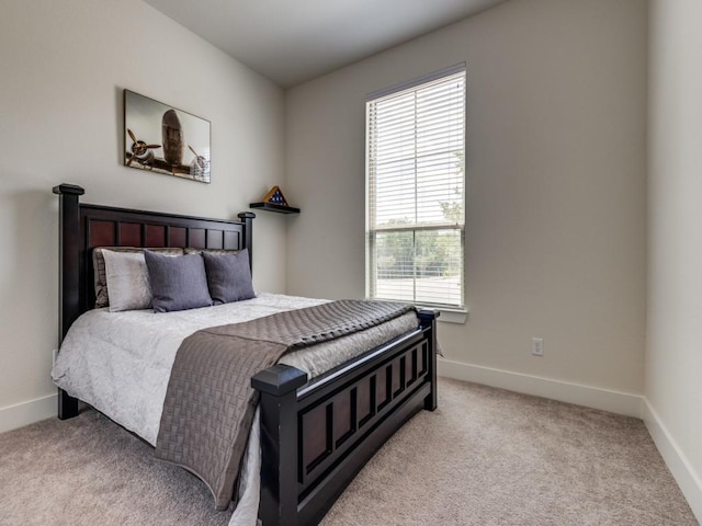 carpeted bedroom with multiple windows