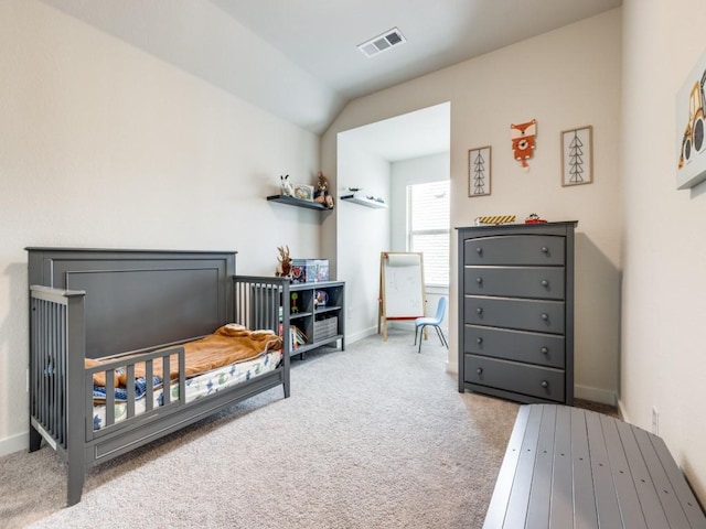 carpeted bedroom with lofted ceiling