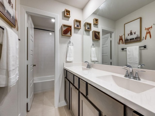 bathroom featuring tile patterned floors, vanity, and tiled shower / bath combo