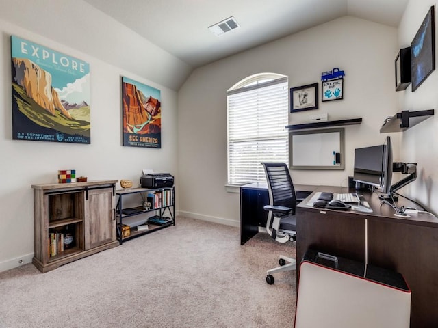 carpeted office space featuring vaulted ceiling