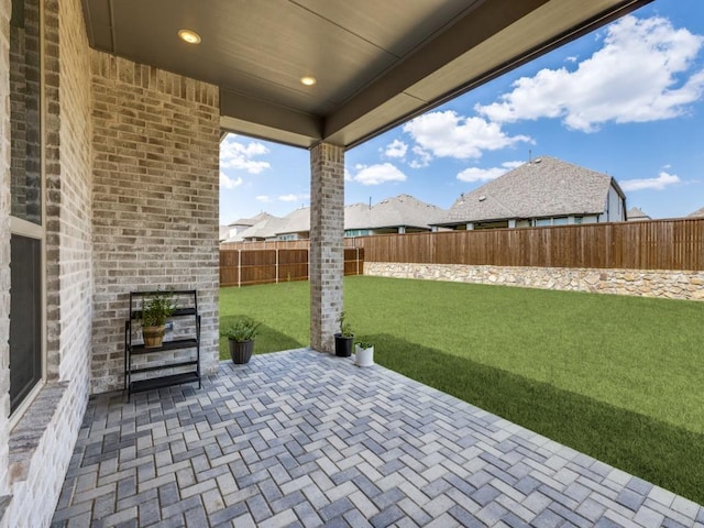 view of patio with an outdoor brick fireplace