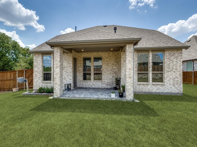 rear view of house with a patio area and a yard