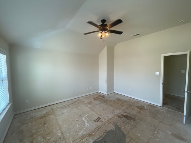 unfurnished room featuring a healthy amount of sunlight, ceiling fan, and vaulted ceiling