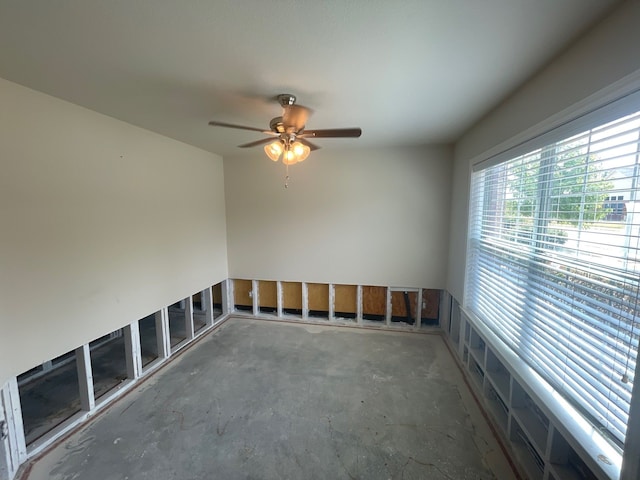 spare room with concrete floors and ceiling fan