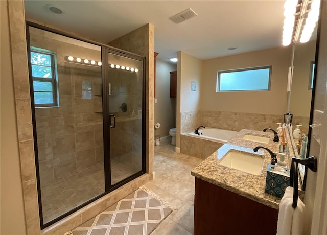 full bathroom with tile patterned flooring, toilet, shower with separate bathtub, and vanity