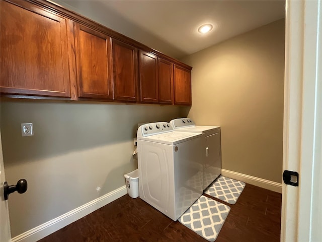 laundry area featuring dark hardwood / wood-style flooring, cabinets, and washer and dryer