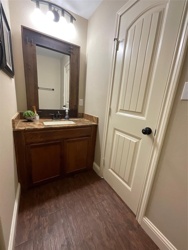 bathroom featuring hardwood / wood-style flooring and vanity