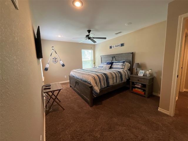 bedroom with ceiling fan and dark colored carpet