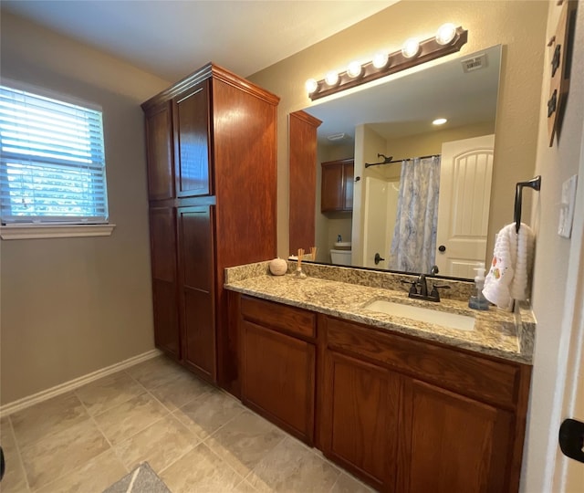 bathroom featuring vanity, toilet, and a shower with shower curtain