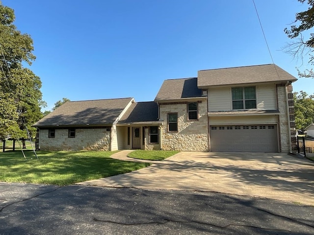 view of front of property with a garage and a front lawn