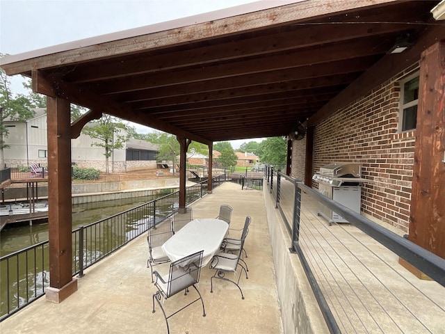 view of patio featuring grilling area and a water view