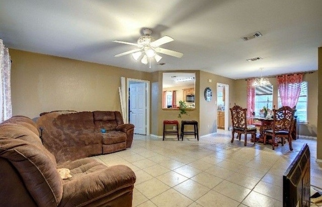 living room featuring a wealth of natural light and ceiling fan