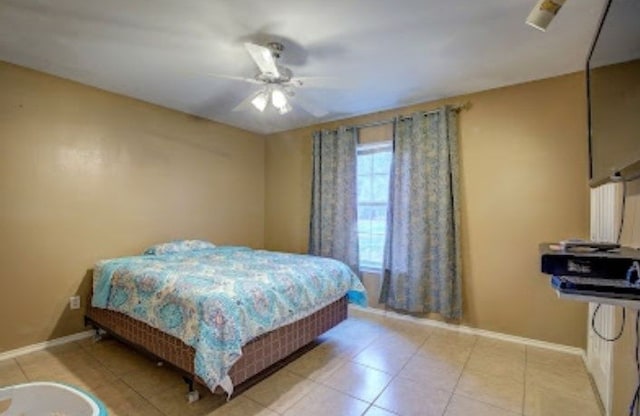 bedroom featuring ceiling fan and light tile patterned flooring