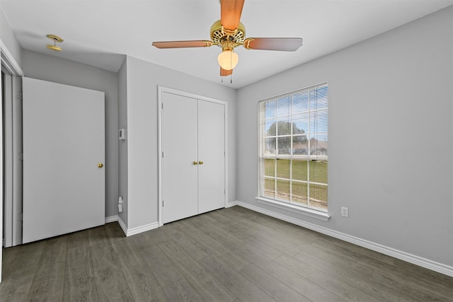 unfurnished bedroom with a closet, wood-type flooring, and ceiling fan