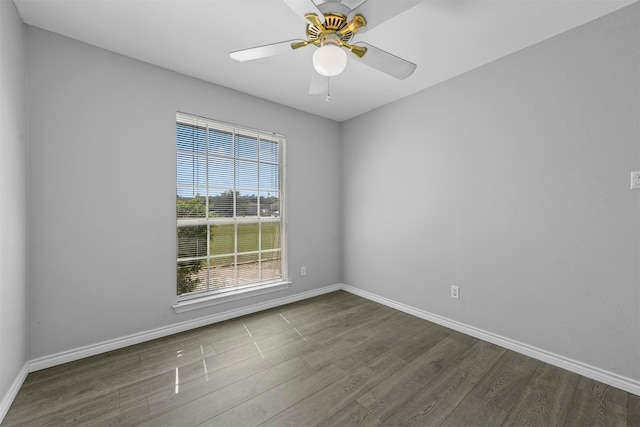 empty room with ceiling fan and dark hardwood / wood-style flooring