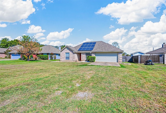 ranch-style home with a front yard, solar panels, and a garage