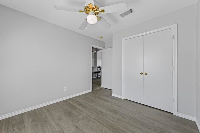 unfurnished bedroom featuring ceiling fan, a closet, and light hardwood / wood-style flooring