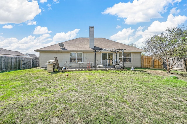 back of property with a yard, a pergola, and a patio