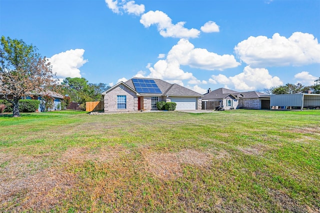 view of front of property with a front yard and a garage