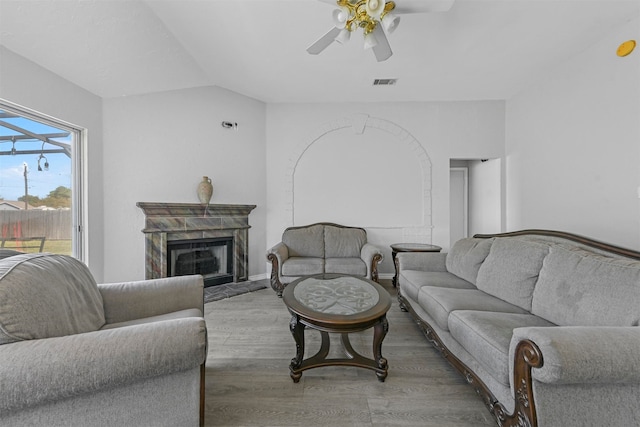 living room featuring vaulted ceiling, ceiling fan, and hardwood / wood-style flooring