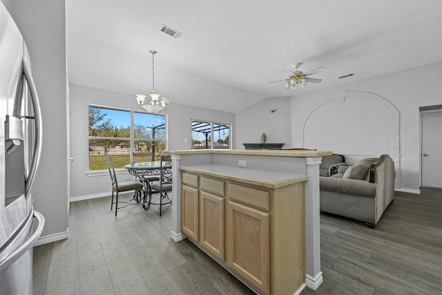 kitchen featuring ceiling fan with notable chandelier, lofted ceiling, stainless steel fridge with ice dispenser, and a wealth of natural light