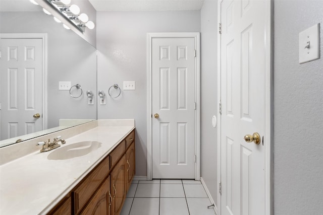 bathroom with tile patterned flooring and vanity