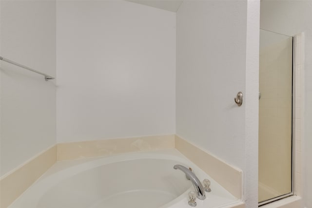 bathroom featuring plus walk in shower