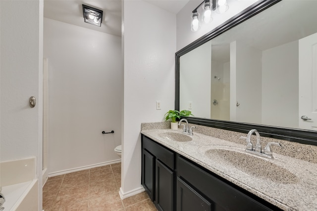 bathroom featuring tile patterned flooring, vanity, toilet, and a bath