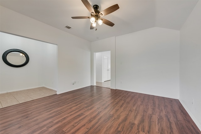 spare room with ceiling fan, hardwood / wood-style flooring, and vaulted ceiling