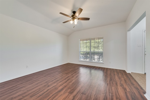 spare room featuring ceiling fan, vaulted ceiling, and dark hardwood / wood-style flooring