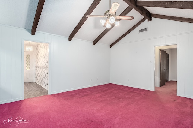 carpeted empty room featuring ceiling fan and vaulted ceiling with beams