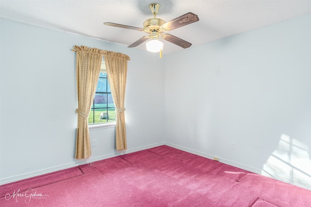 carpeted empty room featuring ceiling fan and a textured ceiling