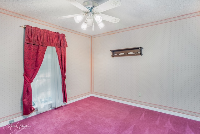 carpeted spare room with a textured ceiling and ceiling fan