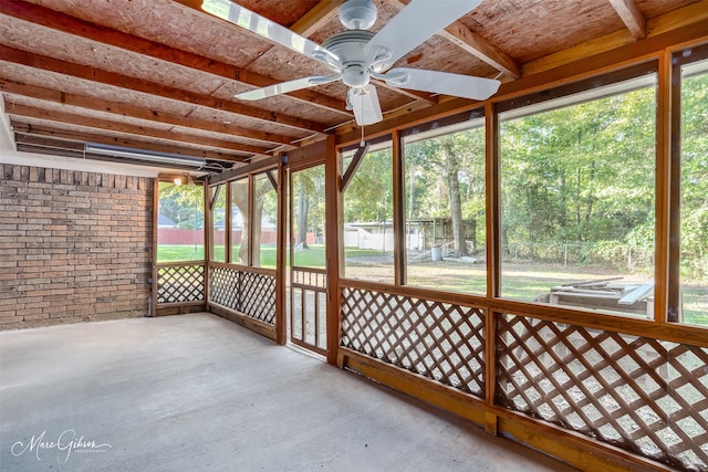 unfurnished sunroom featuring plenty of natural light and ceiling fan