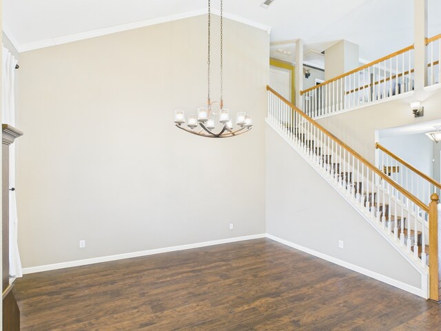 foyer with dark hardwood / wood-style flooring and a towering ceiling