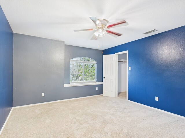 carpeted bedroom featuring ceiling fan and a textured ceiling