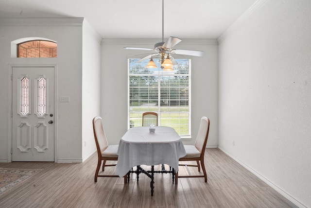 dining room featuring crown molding, ceiling fan, and hardwood / wood-style floors