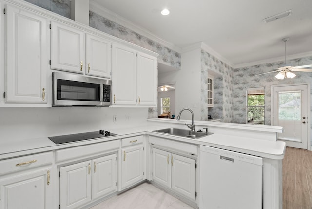 kitchen featuring ornamental molding, a ceiling fan, a sink, stainless steel microwave, and white dishwasher