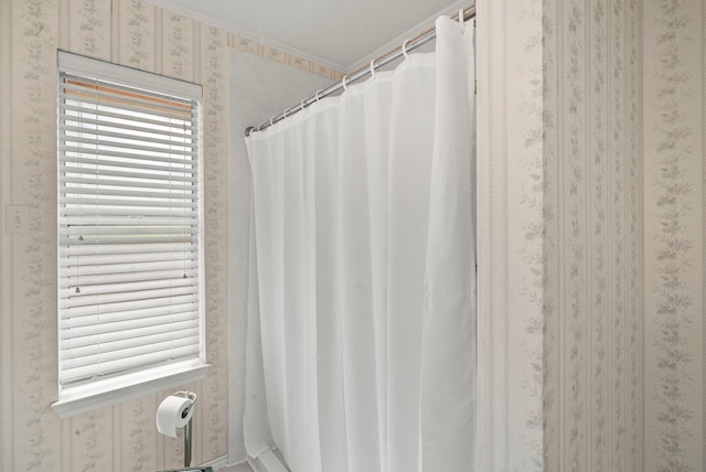 bathroom with wallpapered walls