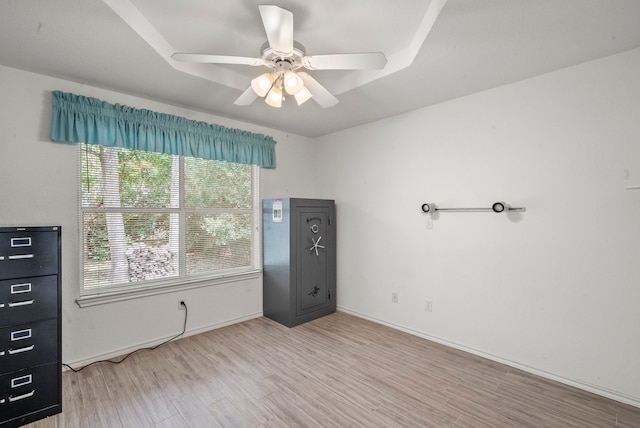 unfurnished bedroom featuring baseboards, wood finished floors, and a ceiling fan