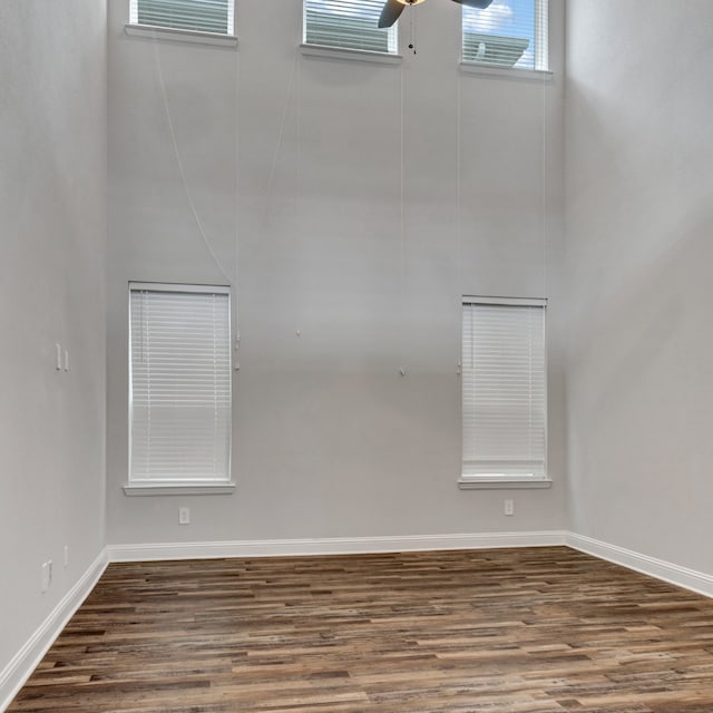 spare room with ceiling fan and dark hardwood / wood-style floors