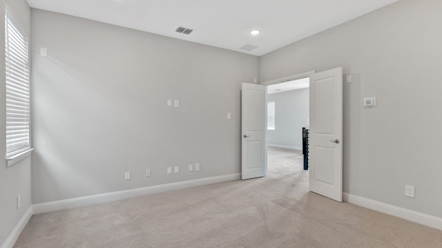 unfurnished room with light carpet