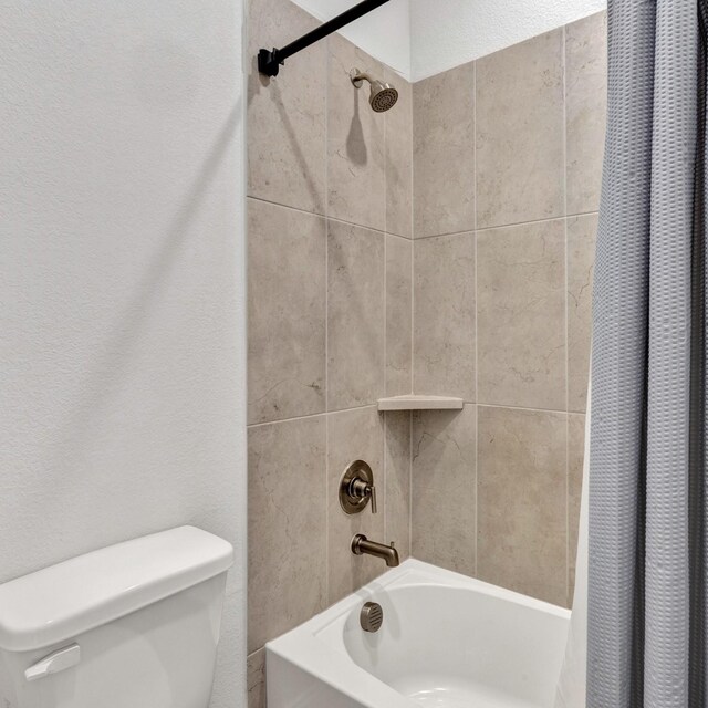 bathroom featuring toilet and shower / bath combo with shower curtain