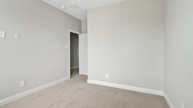 unfurnished room with light colored carpet