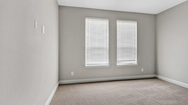 empty room featuring light colored carpet