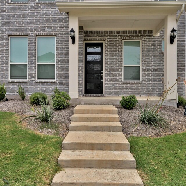 entrance to property with a yard