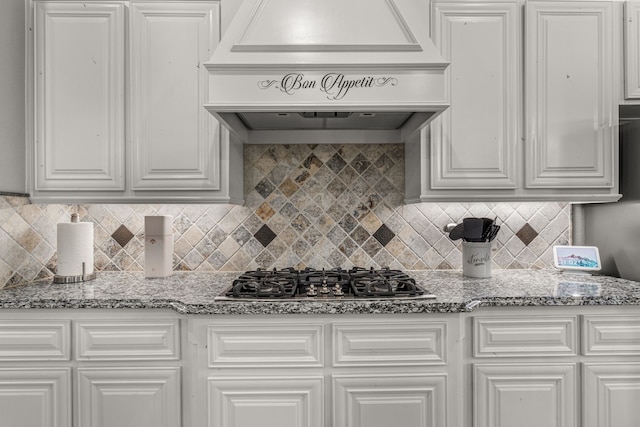 kitchen with white cabinetry, custom range hood, and stainless steel gas cooktop