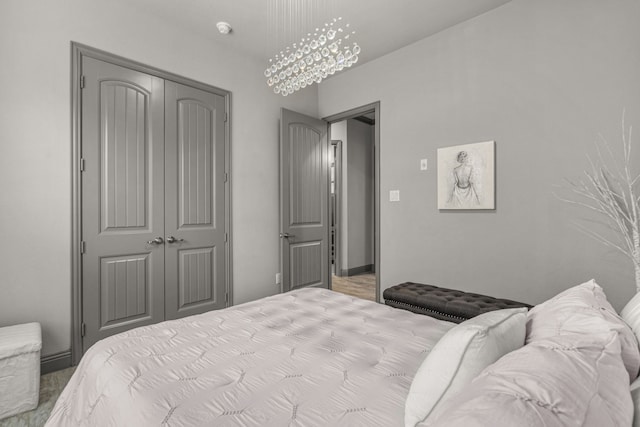 bedroom with a closet and a chandelier